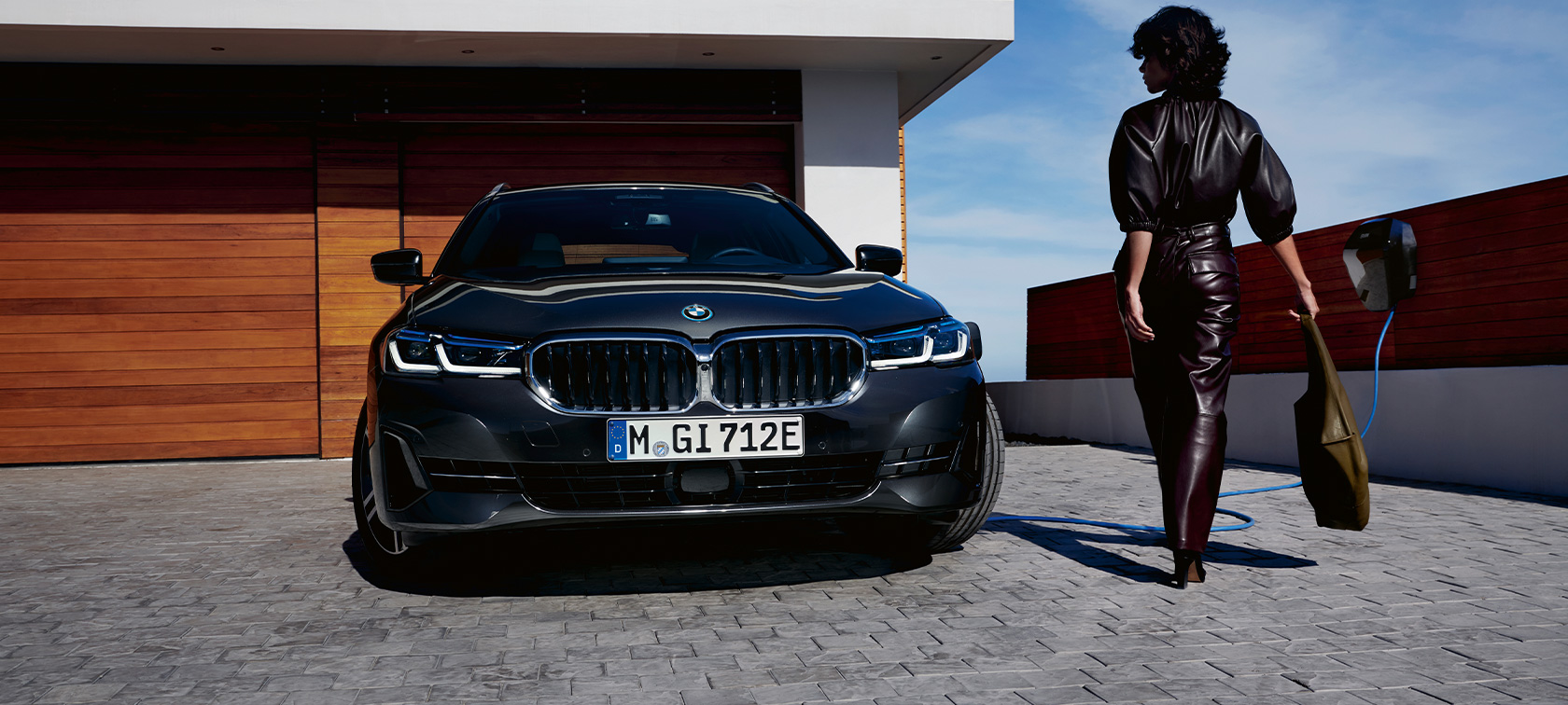 Hybryda plug-in BMW serii 5 Touring 2021 G31, widok z przodu podczas ładowania Hybryda plug-in BMW serii 5 Touring 2021 G31, widok z przodu podczas ładowania z modelem