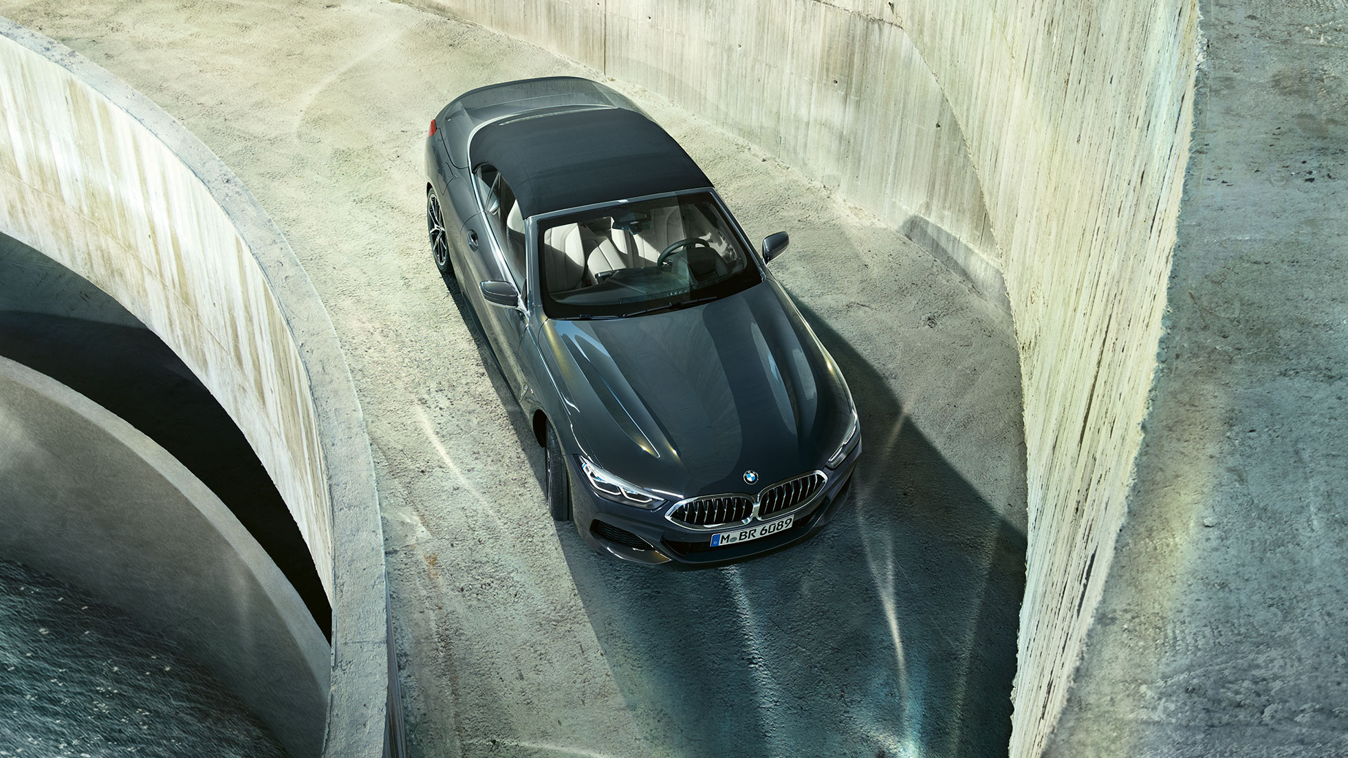 BMW M850i xDrive, szary drawit metalizowany z czarnym miękkim dachem, widok z góry. BMW M850i xDrive, szary drawit metalizowany z czarnym miękkim dachem, widok z góry.
