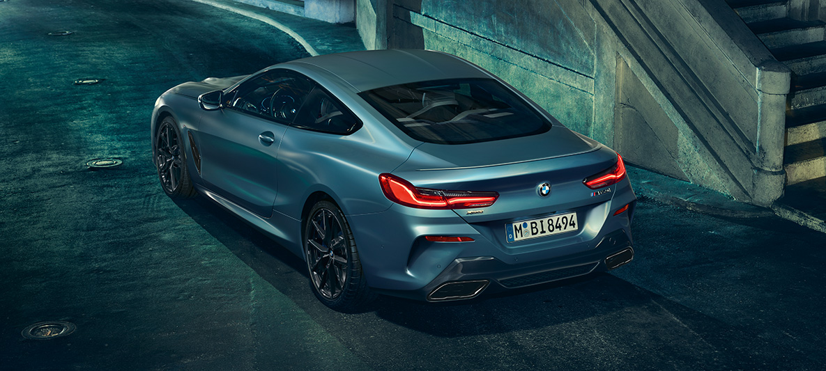 BMW M850i Coupé First Edition, tylny półprofil. Tylny półprofil BMW M850i Coupé First Edition w miejskim otoczeniu