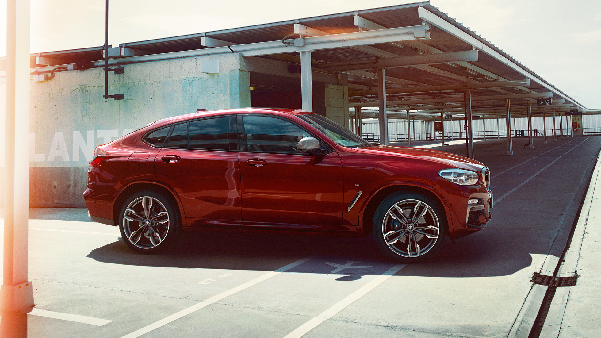 Sportowa sylwetka BMW X4 Sportowa sylwetka BMW X4 M40i G02 2018 czerwień Flamenco z brylantowym połyskiem, widok z boku