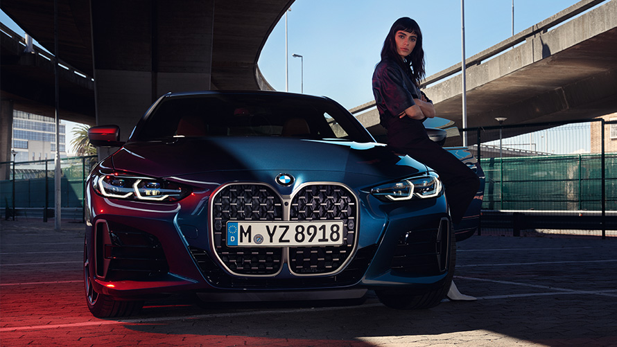 Kobieta opiera się o BMW serii 4 Coupé Zdalna aktualizacja oprogramowania kobieta opiera się o BMW serii 4 Coupé